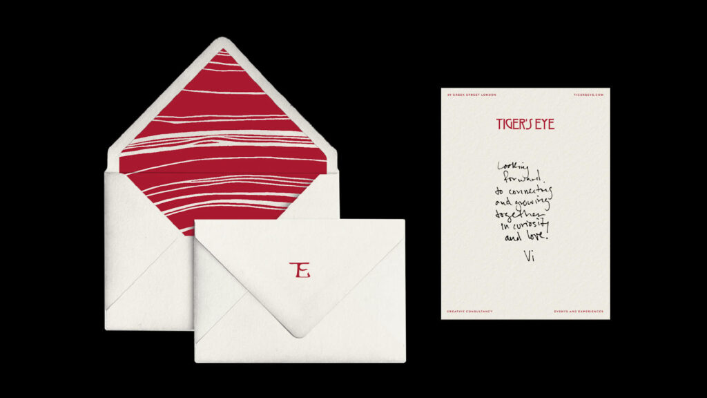 Envelope with Tiger’s Eye elegant red pattern with white stripes on the intern and a letter displaying the agency’s logo and a handwritten thank you message.